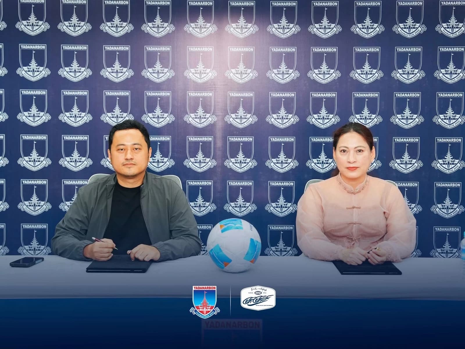 Representatives of Yadanarbon FC and Myint Myint Khin at the signing table
